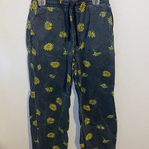 Vans, men’s size S, black joggers with sunflowers.